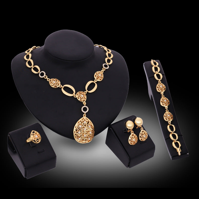 Conjunto de joyería de cuatro piezas: collar, pendientes, pulsera, anillo