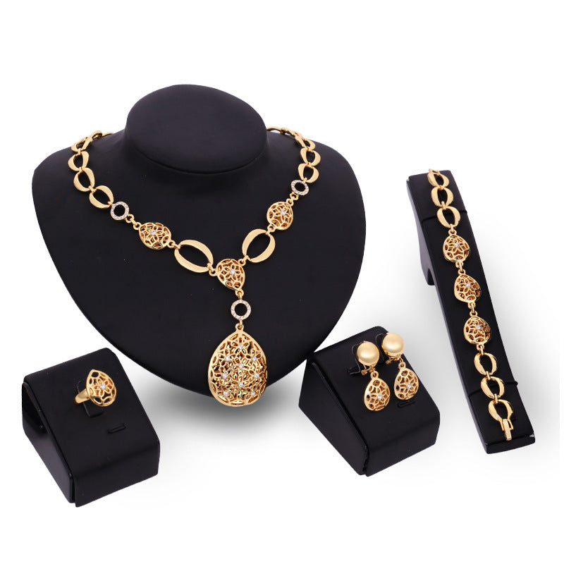 Conjunto de joyería de cuatro piezas: collar, pendientes, pulsera, anillo